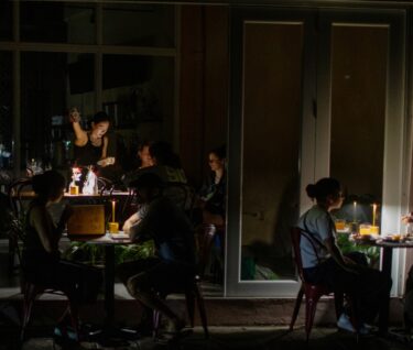 SAN JUAN, PUERTO RICO - APRIL 16: People have dinner at chinese restaurant Santurce during a massive power blackout that affected the entire island on April 16, 2025 in San Juan, Puerto Rico. The cause of the electricity outage is being investigated after all 1.4 million residents of the island lost power on Wednesday. (Photo by Jose Jimenez/Getty Images)