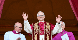 TOPSHOT - Newly elected Pope Leo XIV, Robert Francis Prevost arrives on the main central loggia balcony of the St Peter's Basilica for the first time, after the cardinals ended the conclave, in The Vatican, on May 8, 2025. Robert Francis Prevost was on Thursday elected the first pope from the United States, the Vatican announced. A moderate who was close to Pope Francis and spent years as a missionary in Peru, he becomes the Catholic Church's 267th pontiff, taking the papal name Leo XIV. (Photo by Alberto PIZZOLI / AFP) (Photo by ALBERTO PIZZOLI/AFP via Getty Images)