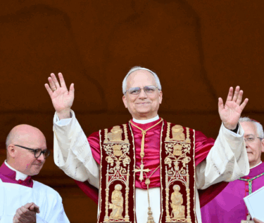TOPSHOT - Newly elected Pope Leo XIV, Robert Francis Prevost arrives on the main central loggia balcony of the St Peter's Basilica for the first time, after the cardinals ended the conclave, in The Vatican, on May 8, 2025. Robert Francis Prevost was on Thursday elected the first pope from the United States, the Vatican announced. A moderate who was close to Pope Francis and spent years as a missionary in Peru, he becomes the Catholic Church's 267th pontiff, taking the papal name Leo XIV. (Photo by Alberto PIZZOLI / AFP) (Photo by ALBERTO PIZZOLI/AFP via Getty Images)