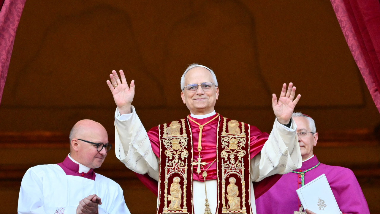 TOPSHOT - Newly elected Pope Leo XIV, Robert Francis Prevost arrives on the main central loggia balcony of the St Peter's Basilica for the first time, after the cardinals ended the conclave, in The Vatican, on May 8, 2025. Robert Francis Prevost was on Thursday elected the first pope from the United States, the Vatican announced. A moderate who was close to Pope Francis and spent years as a missionary in Peru, he becomes the Catholic Church's 267th pontiff, taking the papal name Leo XIV. (Photo by Alberto PIZZOLI / AFP) (Photo by ALBERTO PIZZOLI/AFP via Getty Images)