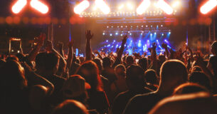Concert Crowd Arms Raised, Audience Cheering, Live Music Event
